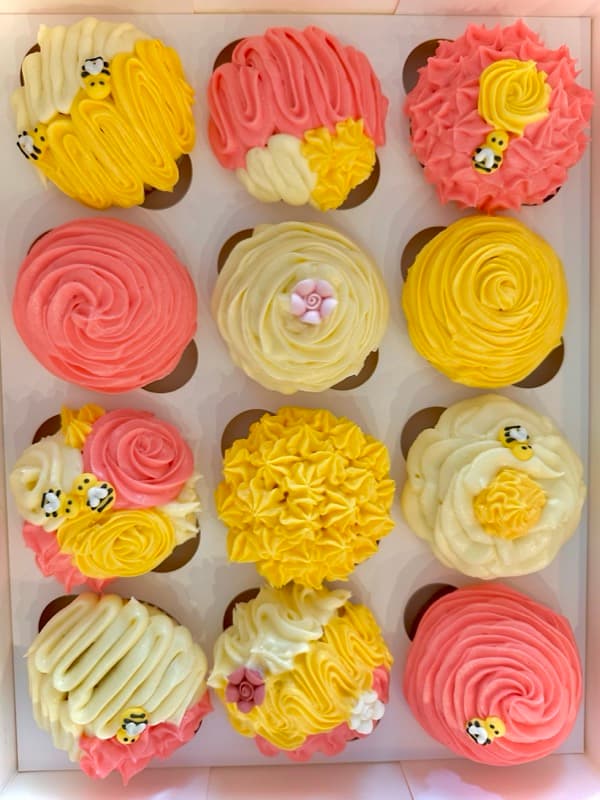 Yellow and pink bee-themed cupcakes